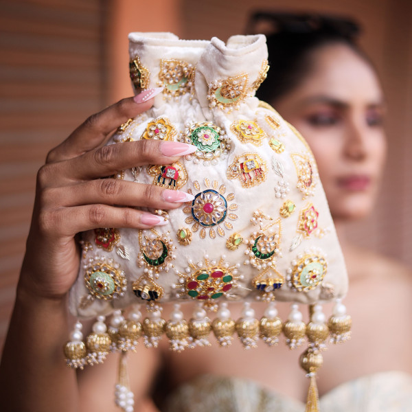 Ivory Velvet Hand-Embroidered Potli Bag with Metal Charms & Tassels