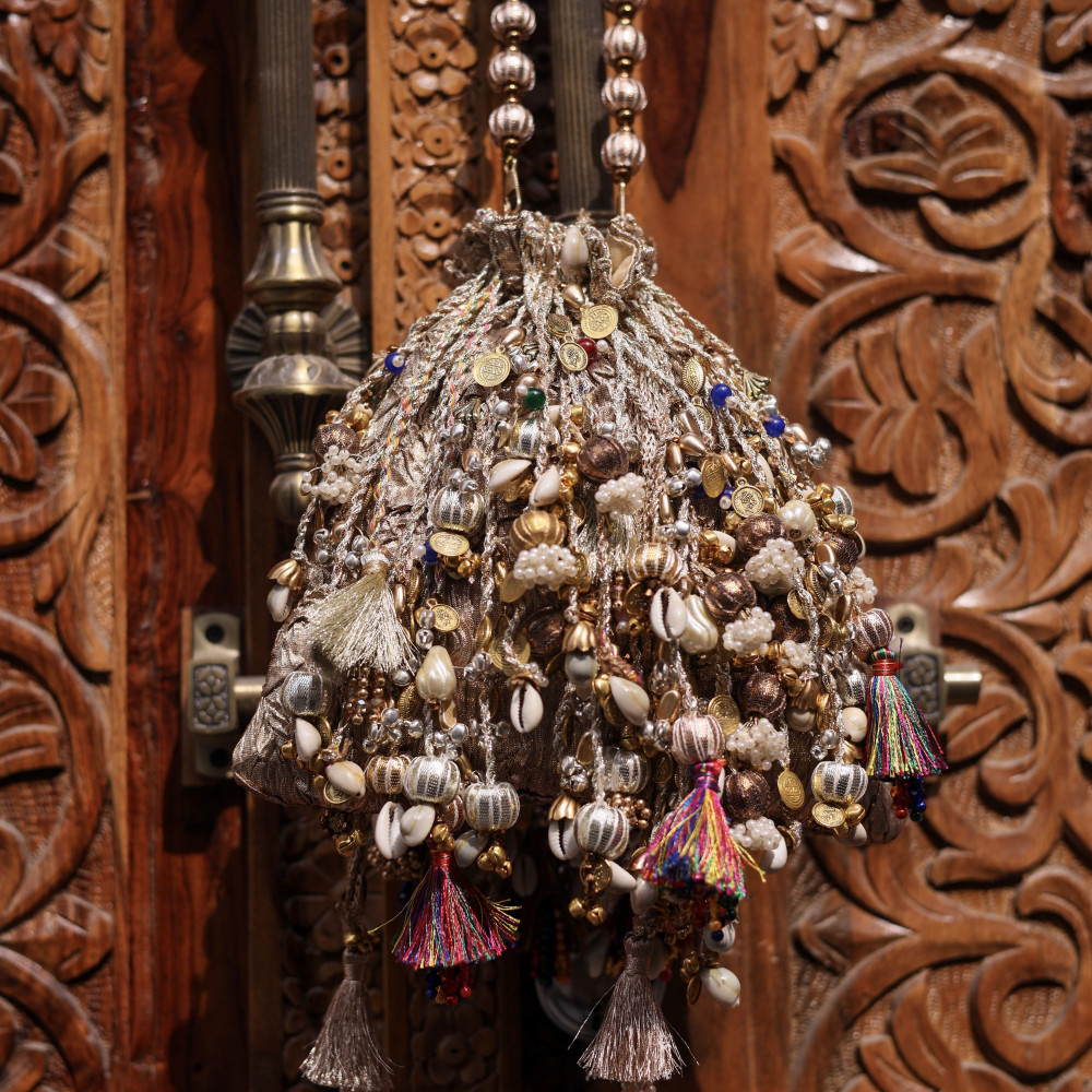 Image of Iconic Antique Gold Crushed Tissue Potli Bag with Embellished Fringes