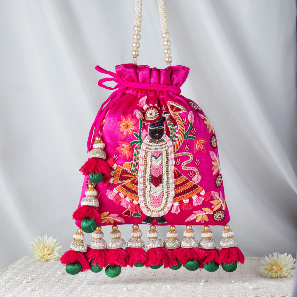 Image of Handcrafted Shrinathji Embroidered Rani Pink Potli – Luxury Velvet Bridal Bag with Jhumka Tassels