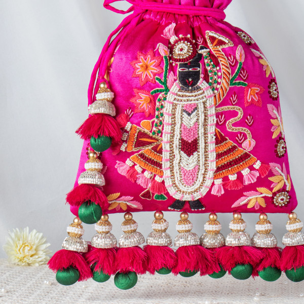 Handcrafted Shrinathji Embroidered Rani Pink Potli – Luxury Velvet Bridal Bag with Jhumka Tassels