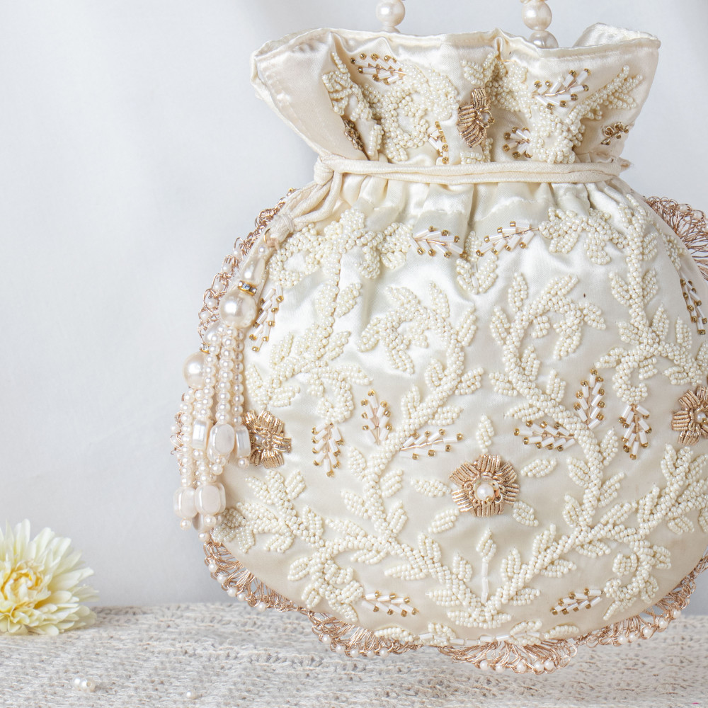 Image of Pearl-Encrusted Ivory Satin Potli Bag – Hand-Beaded Luxe Bridal Pouch ✨?
