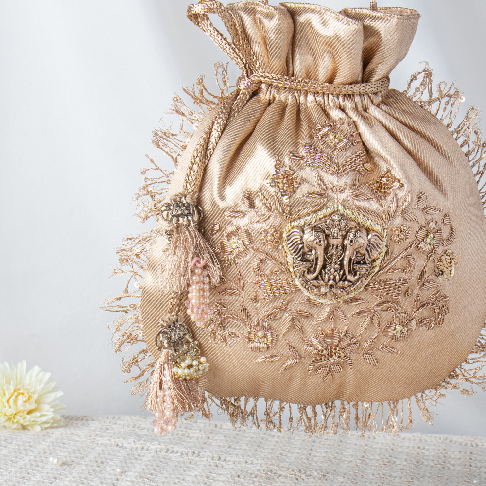 Image of Golden Shimmer Potli Bag with Elephant Motif and Traditional Zari Embroidery ✨?