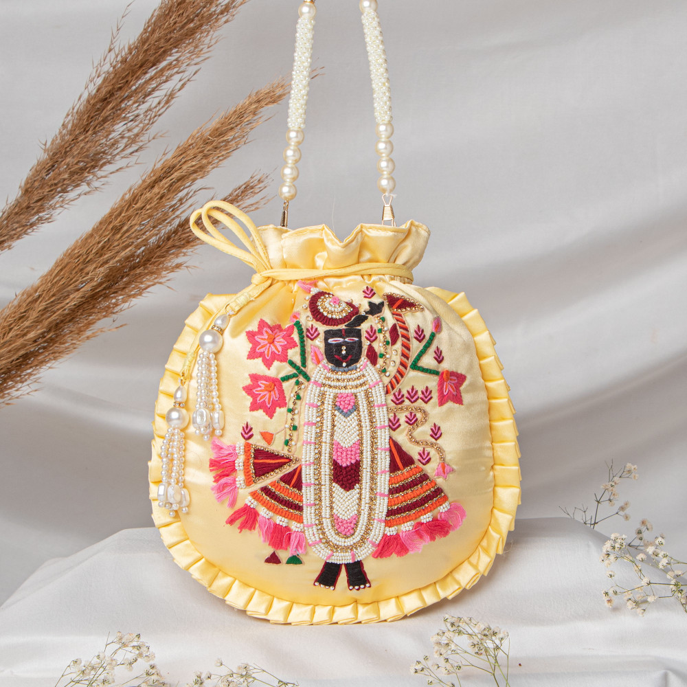 Image of Lemon Yellow  Shrinath Ji Ethnic Potli Bag | Festive Wedding Wristlet in Satin Silk