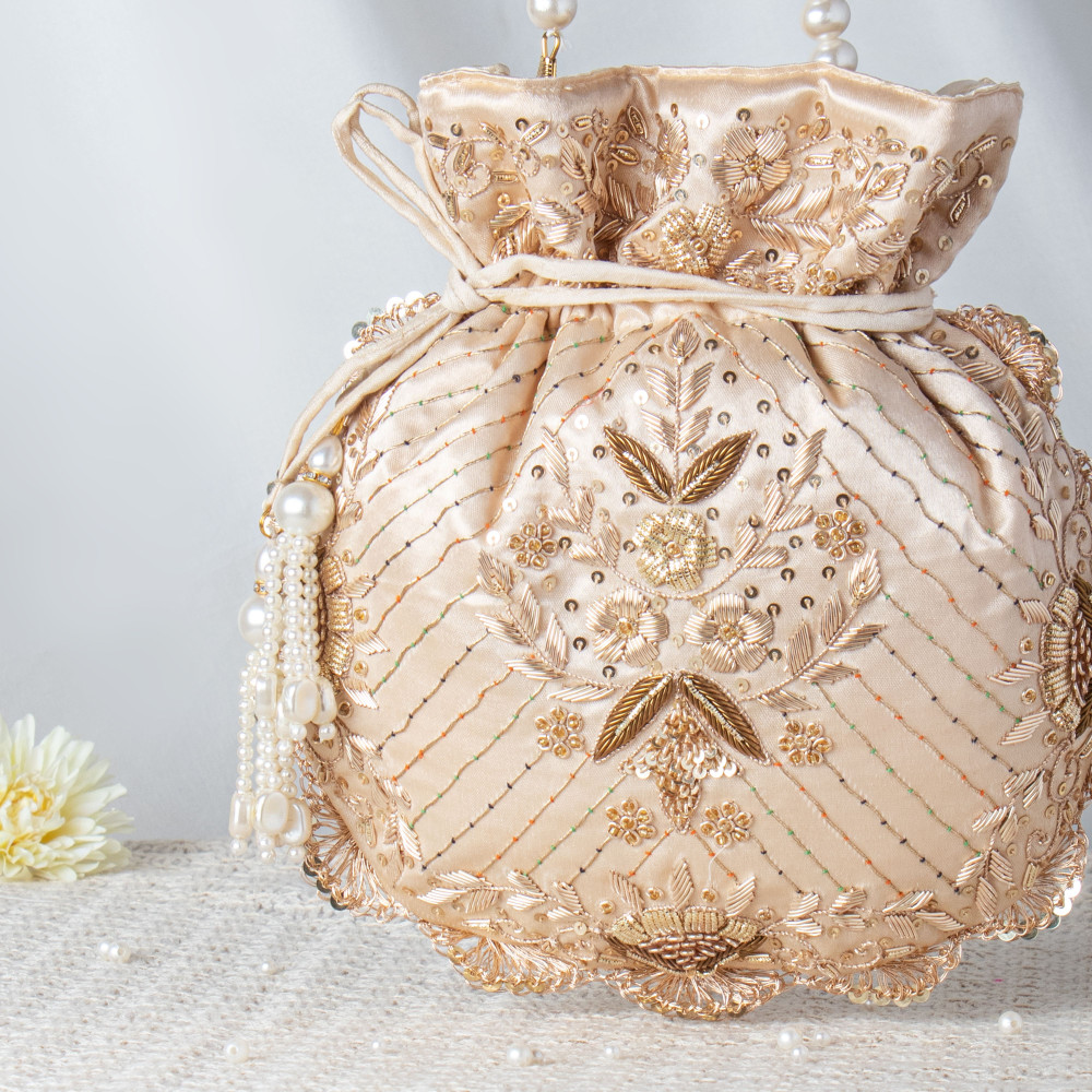 Image of Luminous Beige Satin Potli Bag with Pearl String Handle and Floral Embroidery ??