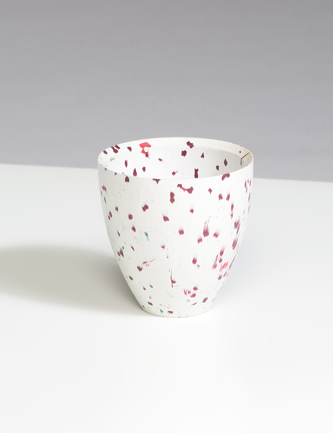 White recycled plastic planter with red spots