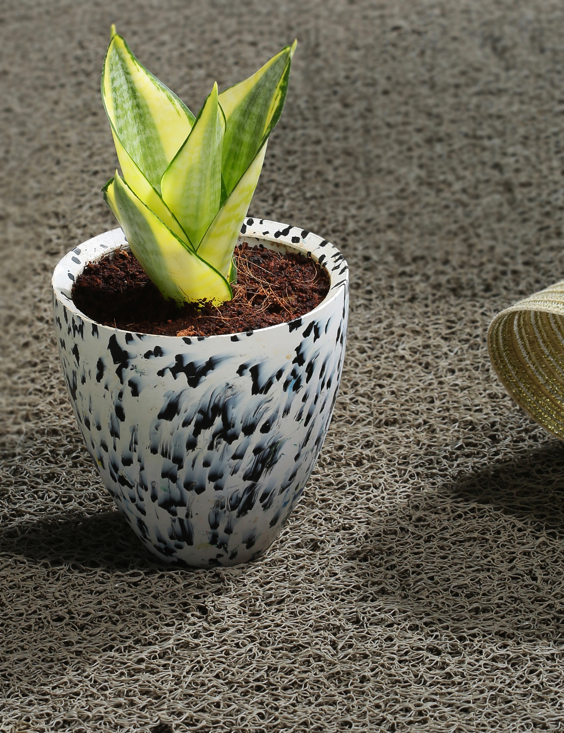 White recycled plastic planter with black spots