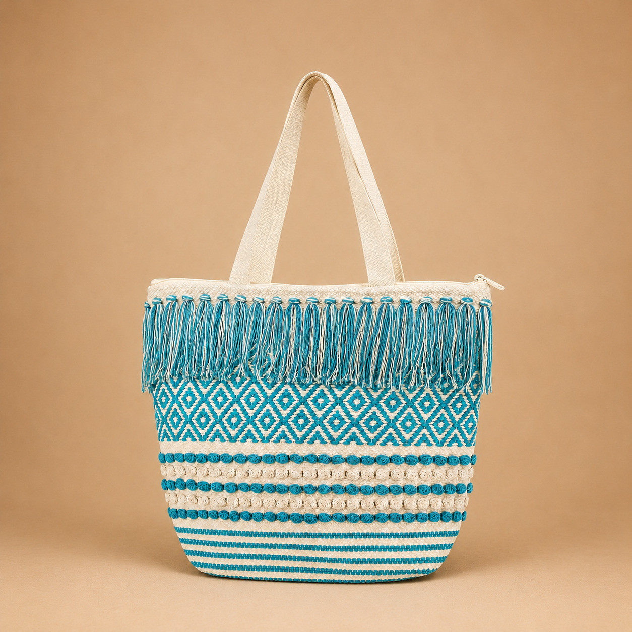Boho woven chevron pom-pom tote bag with teal tassels on ivory base