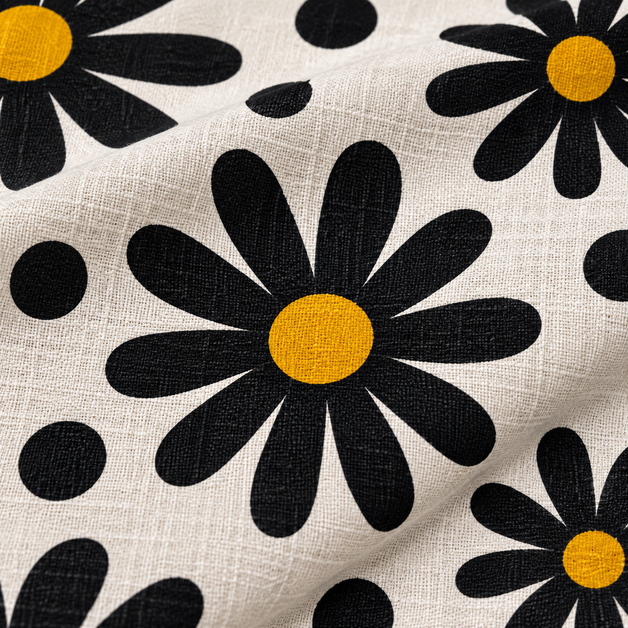 Close-up of black daisy and polka dot print texture on cotton fabric