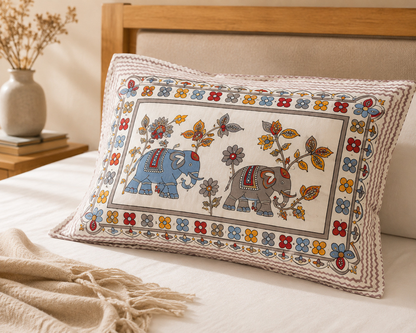 Close-up of pillow cover front showing hand block printed elephant pair with butterfly and floral border