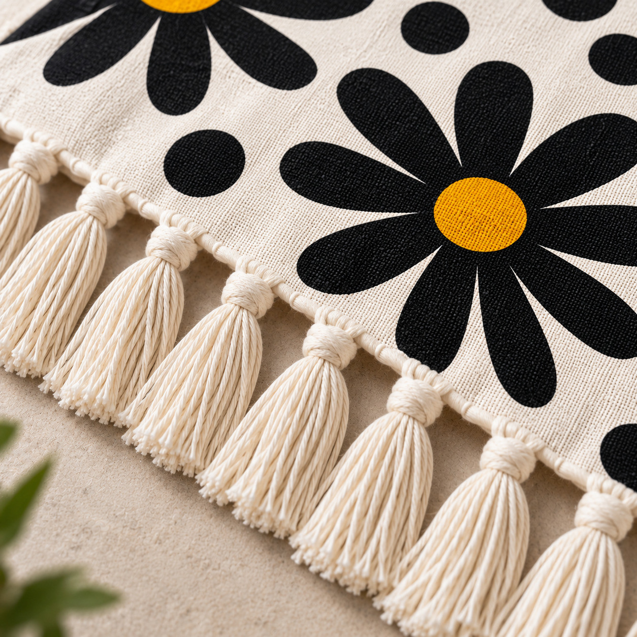 Close-up of tassel fringe on black daisy polka dot cotton sofa throw