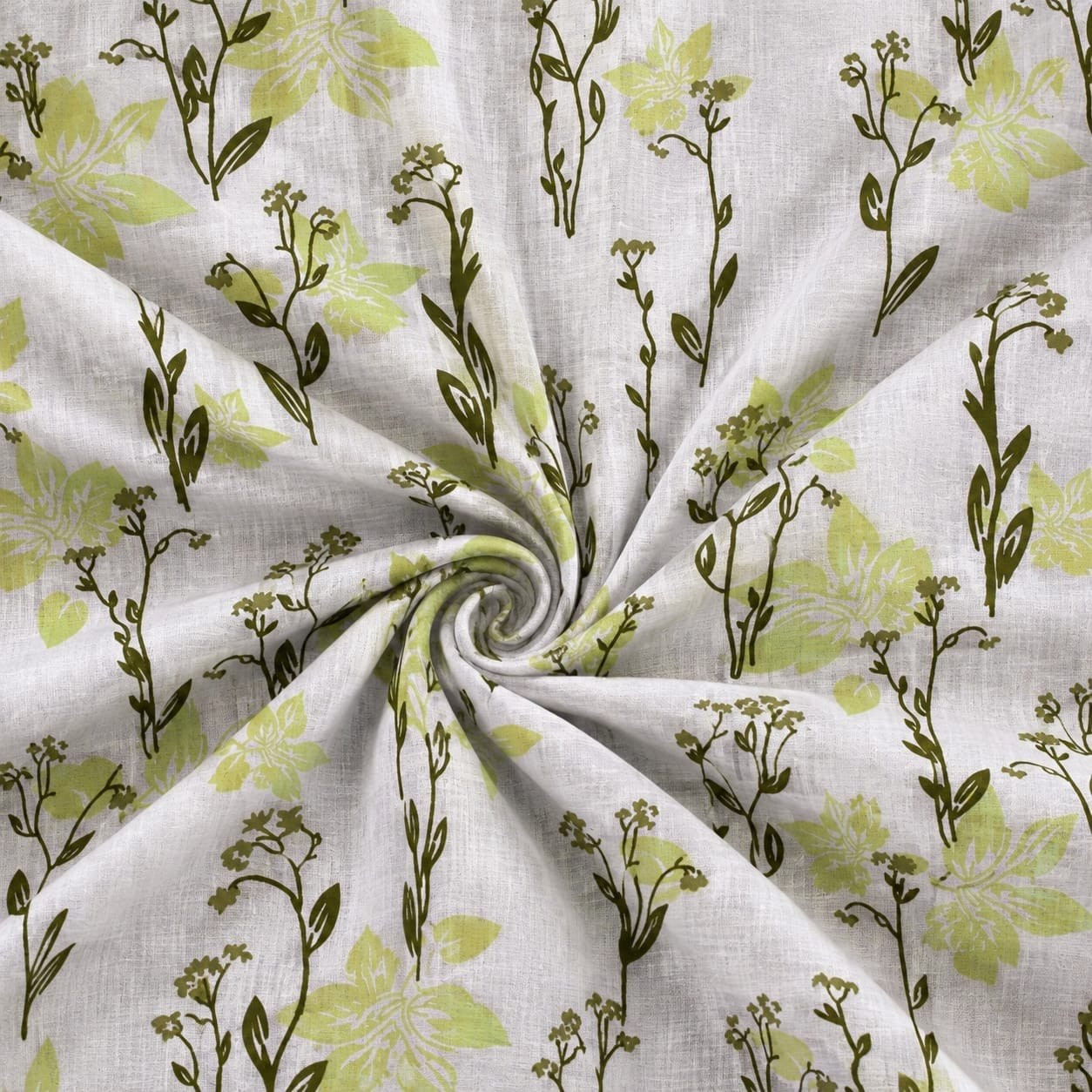 Close-up swirl of hand block printed cotton dohar fabric showing green wildflower pattern