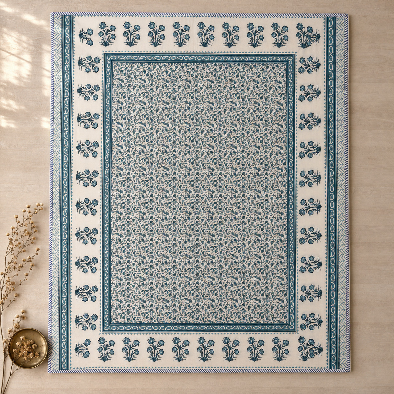 Flat lay of teal floral vine hand block printed cotton dohar showing full paisley and floral bouquet border