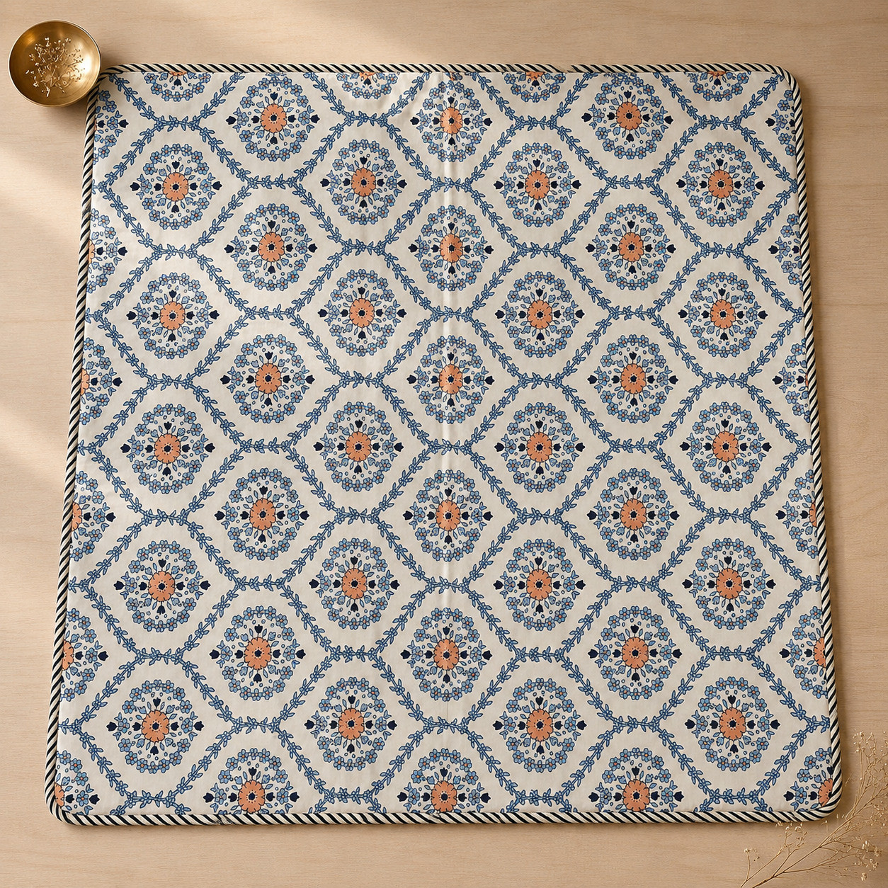 Flat lay top view of indigo medallion hand block printed cotton dohar showing full trellis pattern and corded edge
