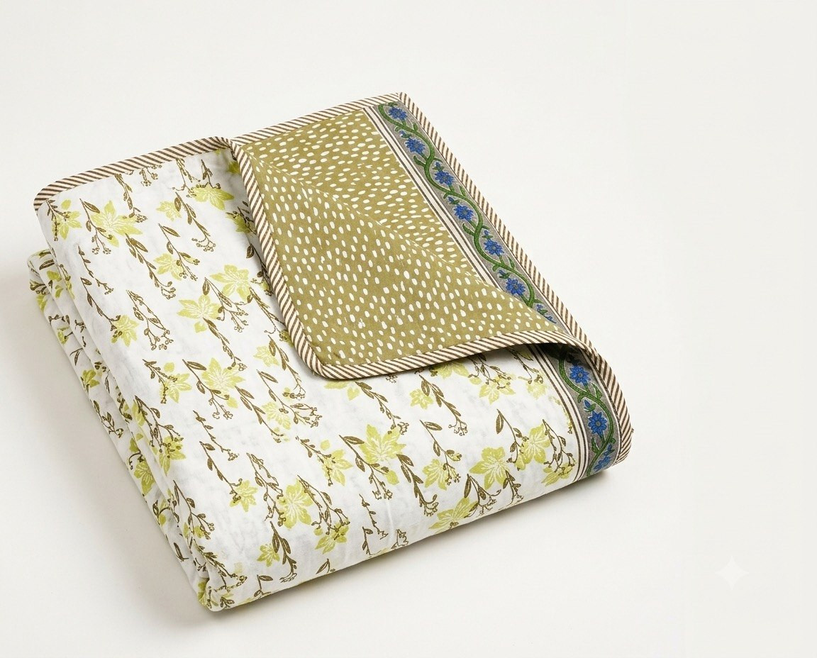 Folded cotton dohar showing green floral print on one side and olive polka-dot floral border on reverse
