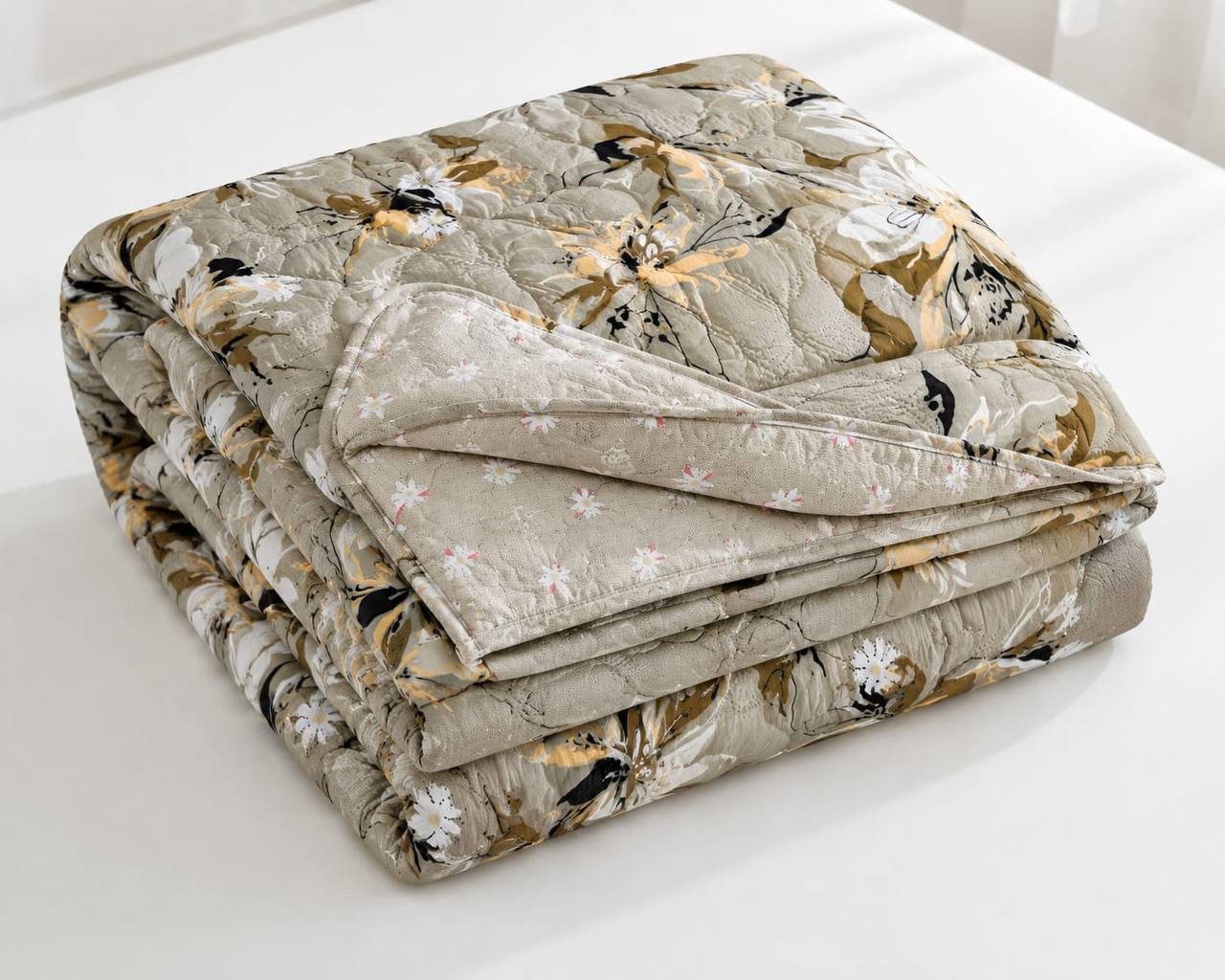Folded double bed cotton quilted comforter in beige floral print with reversible ditsy floral corner flip size 72x90 inches