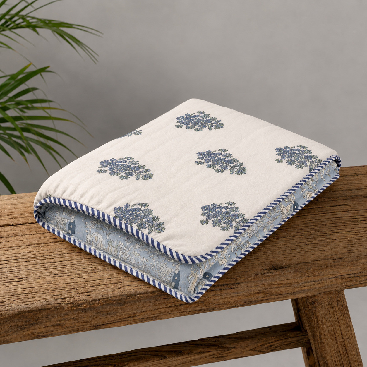 Folded reversible hand block printed dohar showing floral and royal procession prints