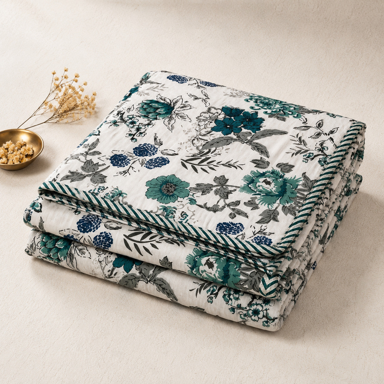 Folded set of 2 teal botanical cotton dohars showing floral print and corded edge detail