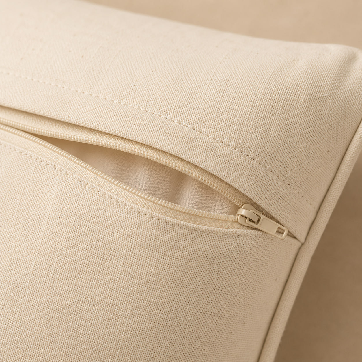 Close-up of boho cushion cover hidden zipper closure on plain cream fabric back