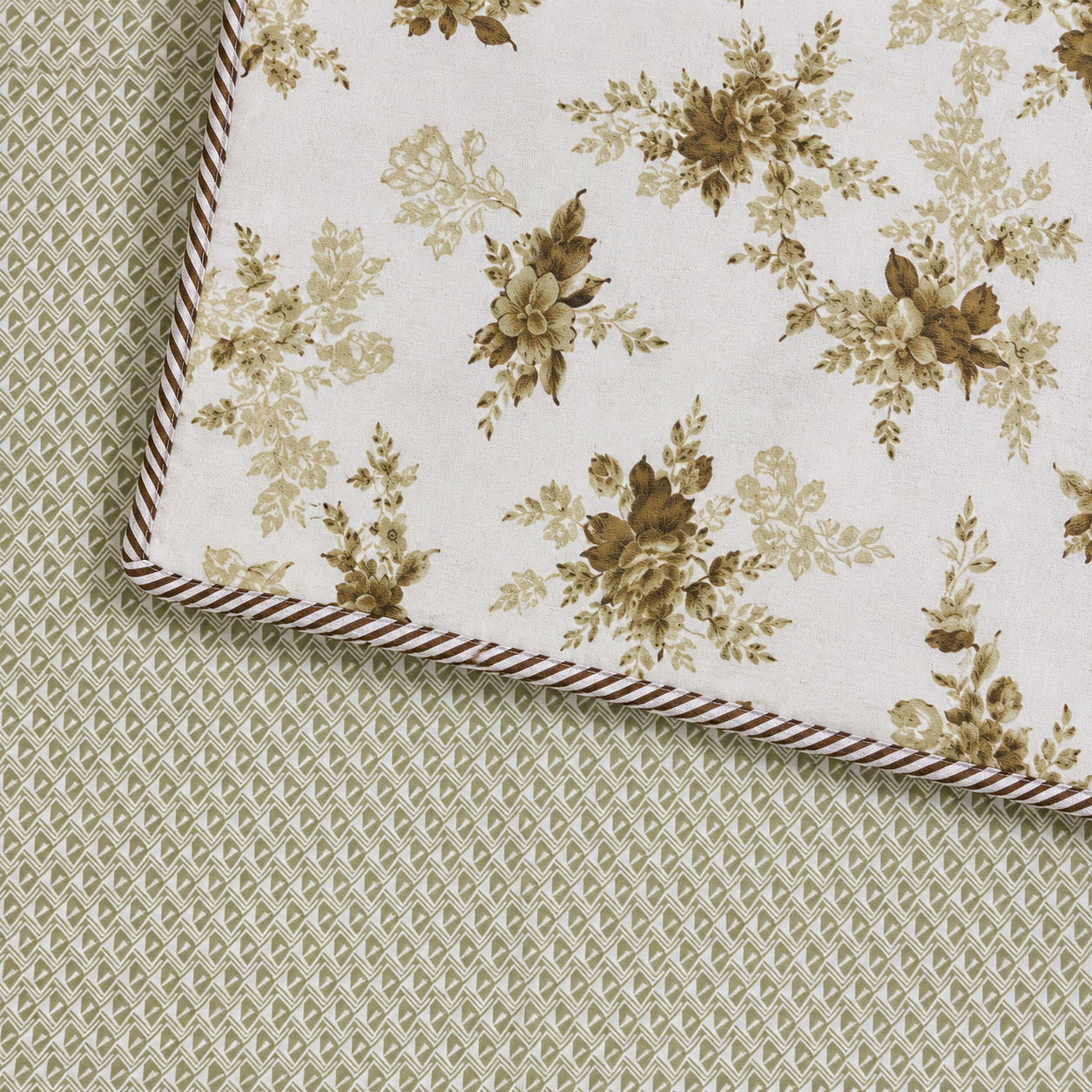 Reversible dohar corner showing floral front and olive geometric diamond print back