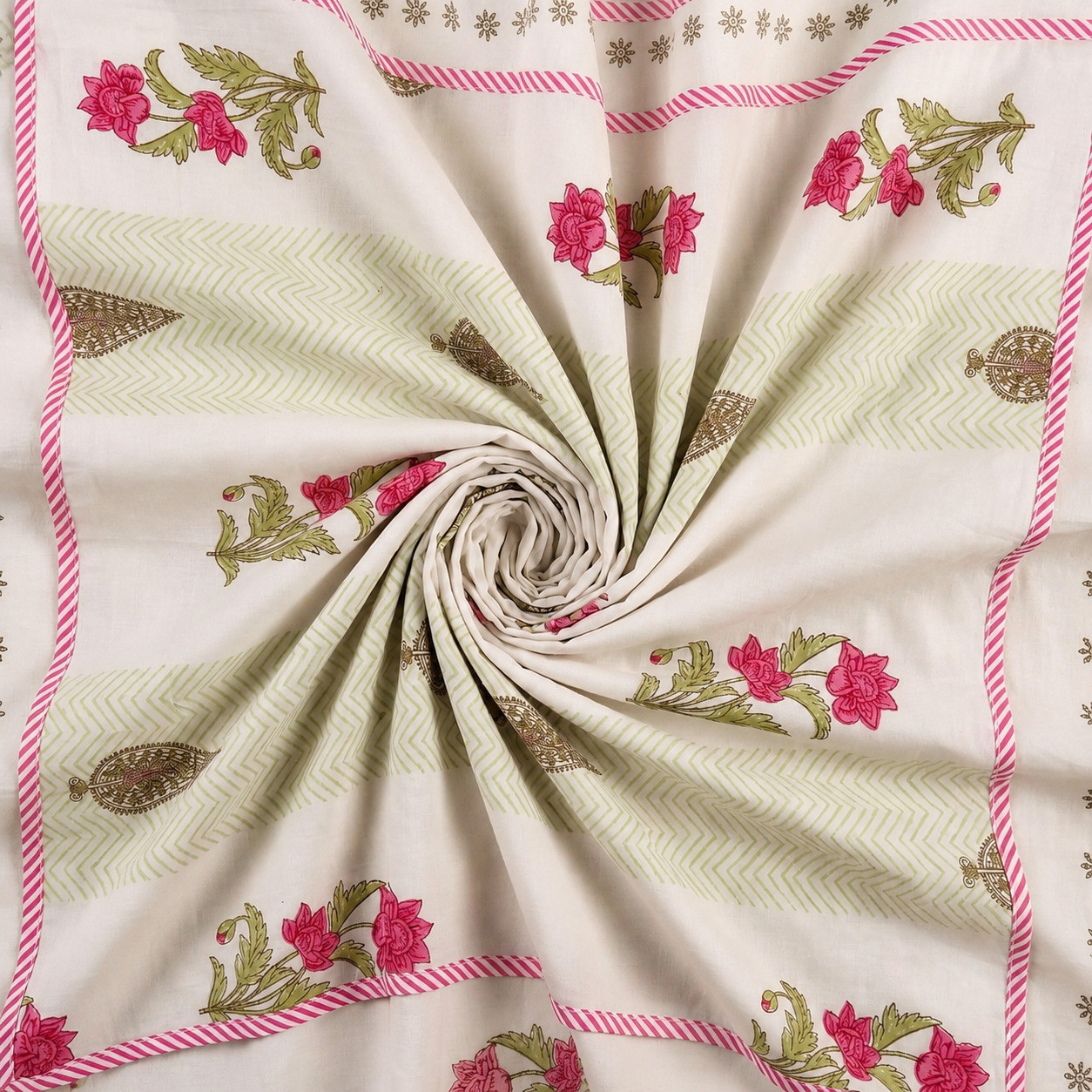 Swirled hand block printed cotton dohar showing pink floral and paisley pattern with striped border